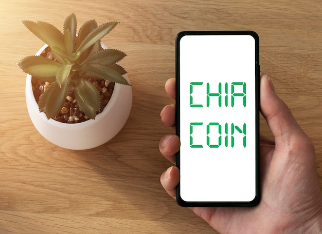 A smartphone with an app showing an automatic savings transfer being set up. The screen displays options for scheduling recurring transfers and setting savings goals.