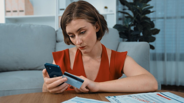 A person using a budgeting app on their smartphone while sitting at a coffee shop, highlighting various categories like 