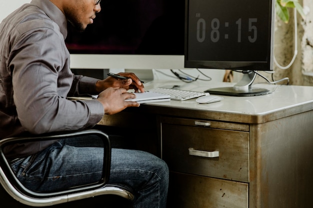 A person sitting at a desk, using a computer to access AnnualCreditReport.com. The website is clearly visible on the screen, and the person is shown filling out the form to request a credit report. The image conveys ease of access and the straightforward process of obtaining a credit report online.