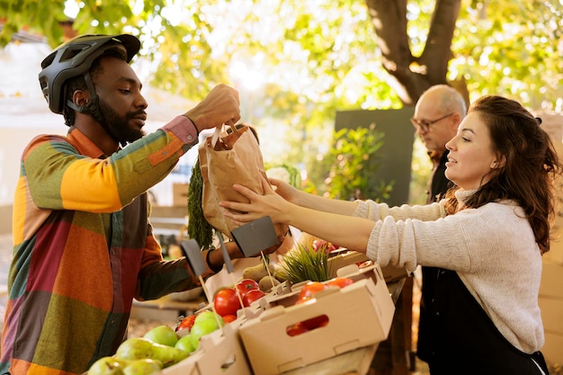A person holding a basket of groceries at a farmers market, emphasizing the fresh produce and the potential savings compared to eating out.