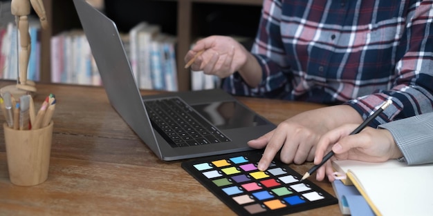 A person using a laptop with various personal finance software tiles visible on the screen. Icons for budgeting apps, banking portals, and investment platforms are displayed.