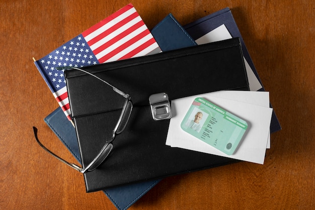 A close-up shot of a foreign passport next to a calculator and US tax forms.