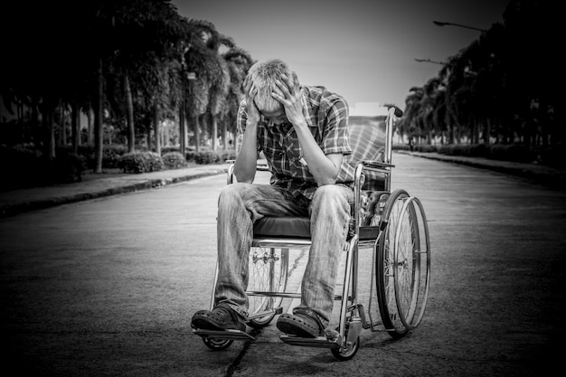 A split image showing on one side a person using a wheelchair and on the other side an elderly person with gray hair, both smiling gently. The background is a soft, blurred image of a park, highlighting the inclusion and support for eligible individuals.