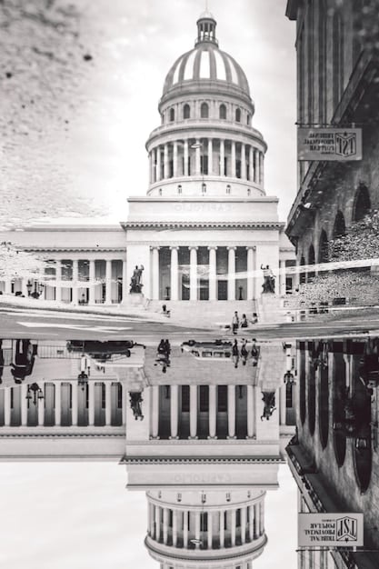 A split image comparing the U.S. Capitol Building (representing Congress) and the U.S. Treasury Building (representing the Treasury Department), symbolizing their shared responsibility in managing the federal debt ceiling.