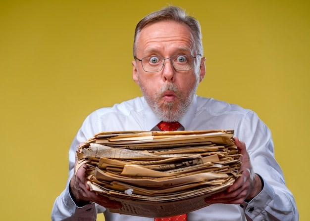 An image showing a small business owner looking overwhelmed by a stack of paperwork, representing the compliance burden of government regulations.