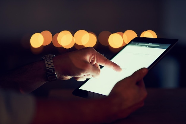 A person reviewing a list of subscriptions on a tablet, with some subscriptions highlighted and others crossed out, symbolizing the process of identifying and cancelling unnecessary services.