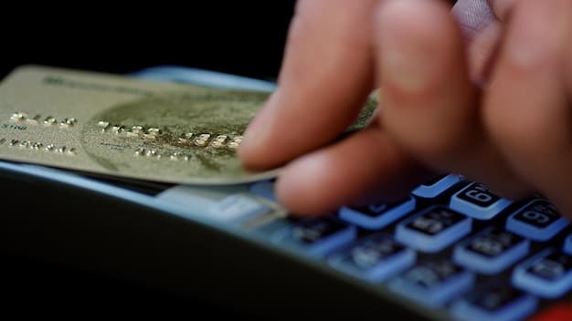 Close-up image of a credit card being swiped with a calculator and bills in the background indicating high debt.